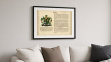 
Wczytaj obraz do galerii, Matching black frame with white mount shown holding a Last Name Origin print (Byrne sample) above a sofa